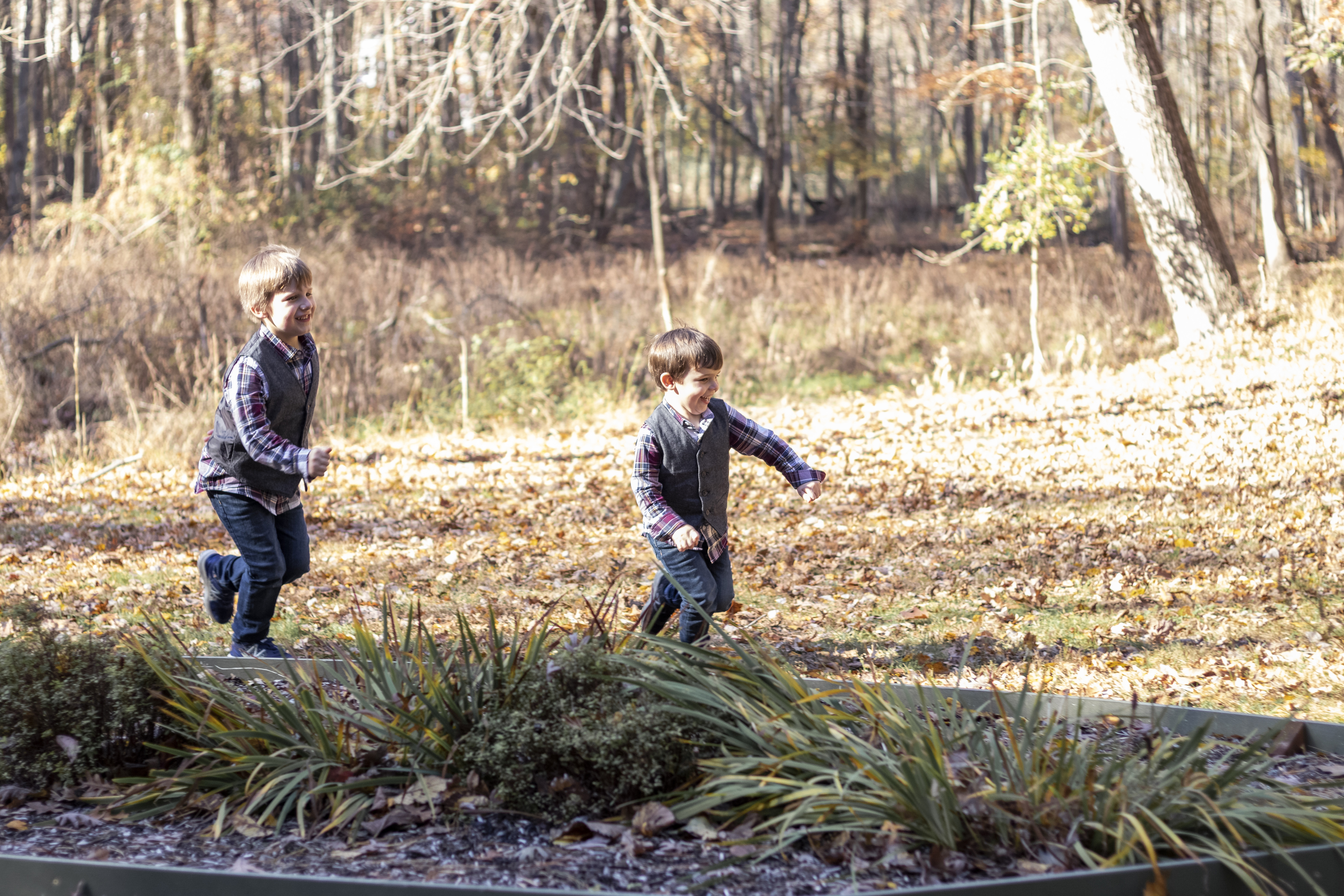Playful Fall Family Portrait with two brothers running in Hillsdale, New Jersey by Jaimee Rae Photography