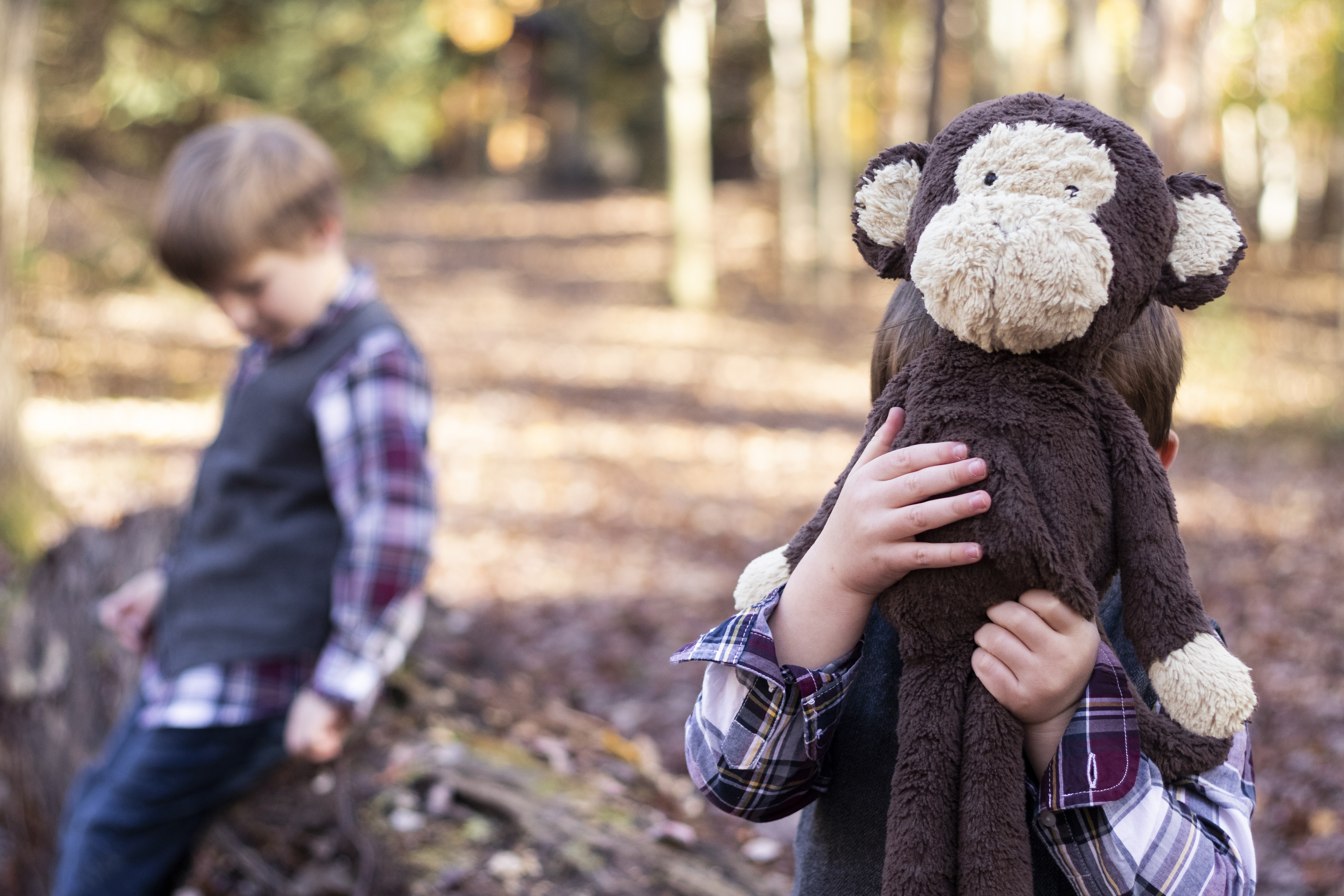 Playful Fall Family Portrait with two brothers and their stuffed animal in Hillsdale, New Jersey by Jaimee Rae Photography